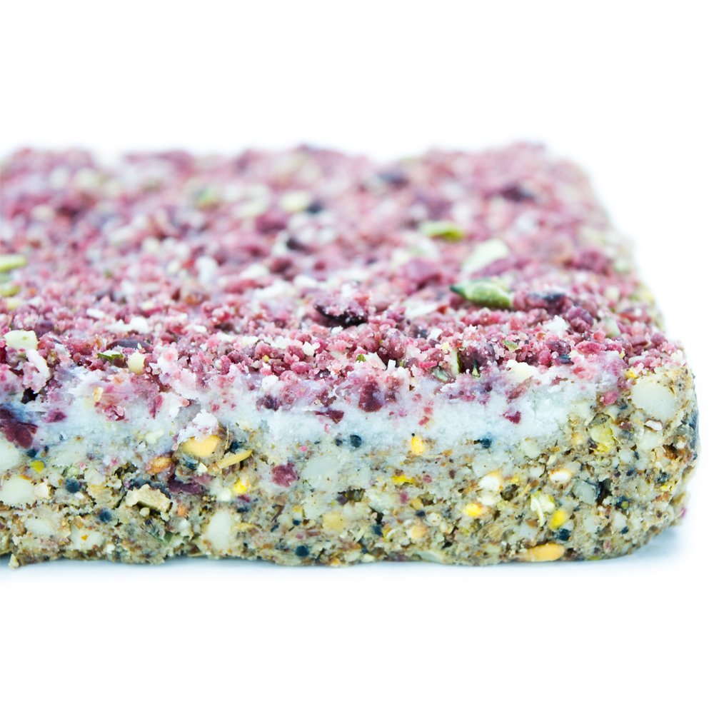 Close-up of a layered suet berry block with pink top and white bottom on a white background