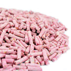 Pink cylindrical suet pellets on a white background