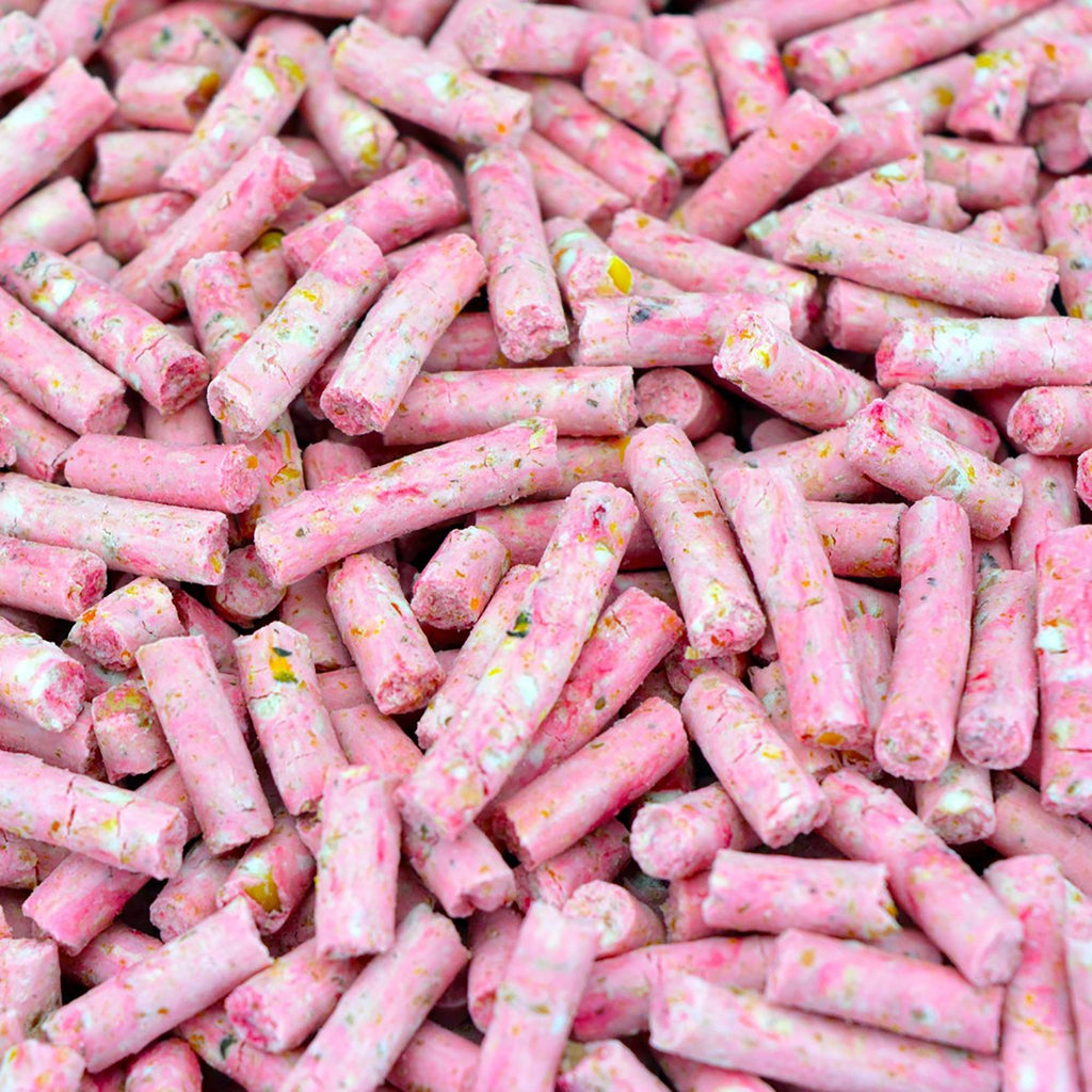 Close-up of pink candy sticks with colorful sprinkles