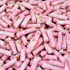 Close-up of pink candy sticks with colorful sprinkles