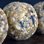 Close-up of a textured fatball with visible ingredients on a dark background