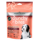 A package of Arden Grange Crunchy Bites skin and coat care treats with fresh salmon, featuring a salmon-colored pouch with a picture of a black and white dog.