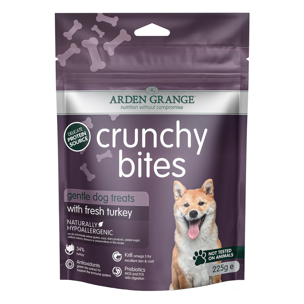 Package of Arden Grange crunchy bites turkey dog treats with a purple background