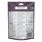 Back of a 225g pouch of Arden Grange crunchy bites turkey Nutritian Without Compromise dog food, featuring extensive text, a barcode, and a green 'Not Tested on Animals' badge on a white background. 