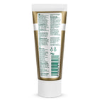 The back of a white squeeze tube with a metallic gold label, showing detailed product information, ingredients, and a barcode on a white background.