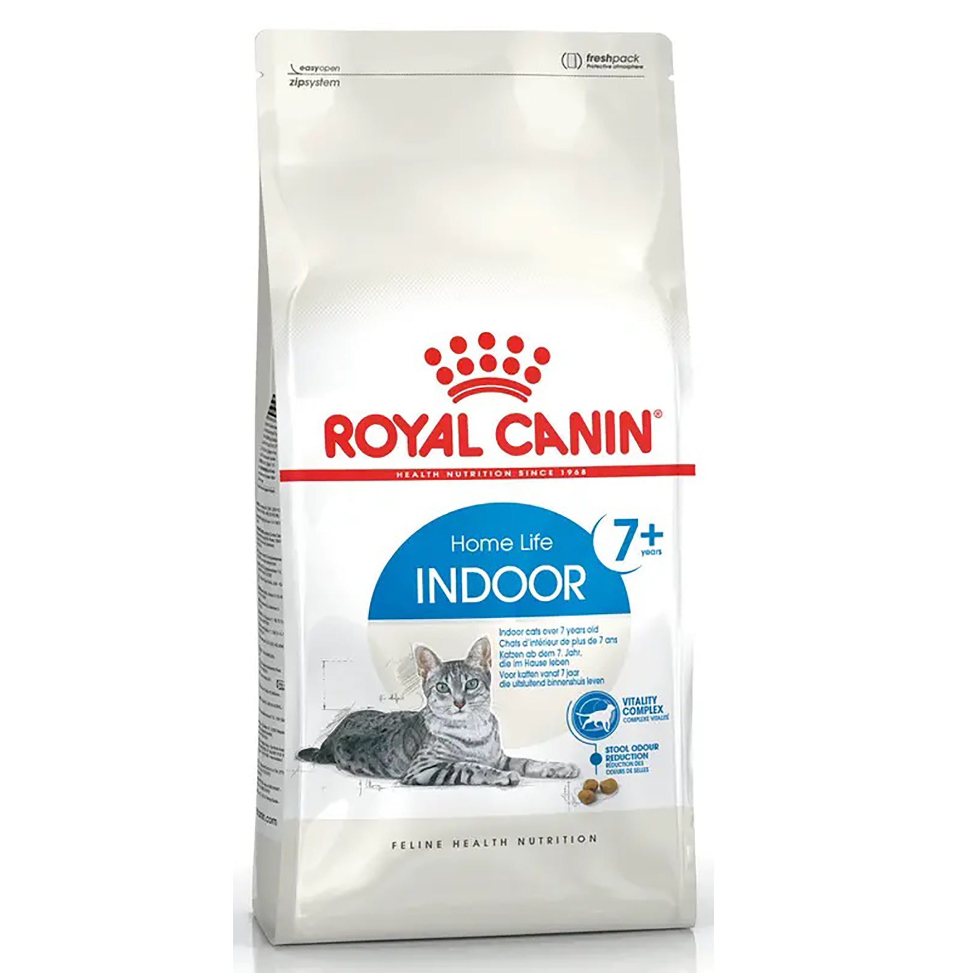 A bag of Royal Canin Home Life Indoor 7+ cat food, featuring a white bag with red and blue branding, a picture of a grey tabby cat, and kibble pieces on a white background.